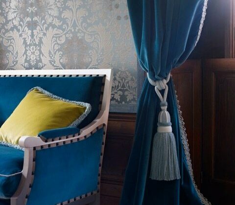 Blue velvet curtains with armchair